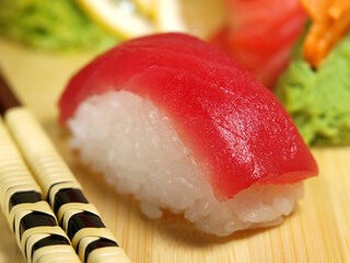 Sushi with tuna on a wooden tray close-up