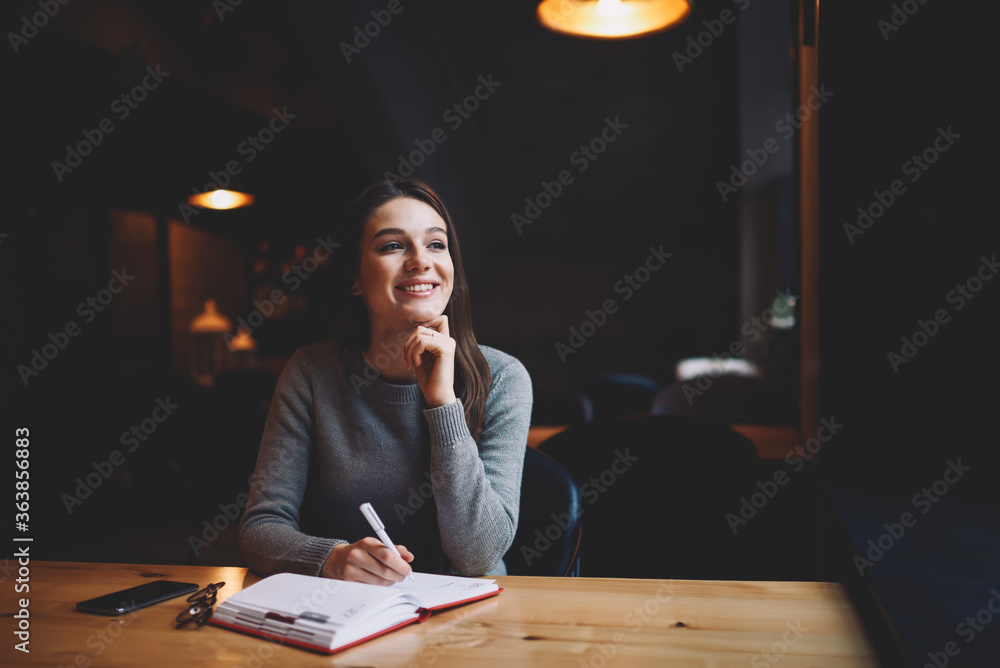 Poster charming attractive female author of articles enjoying working in coffee shop creating new texts wri
