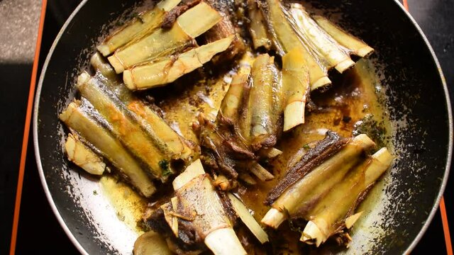 Cooking meat ribs at home. Tabak maaz is traditional kashmiri food made with mutton or lamb ribs. Frying meat in a pan