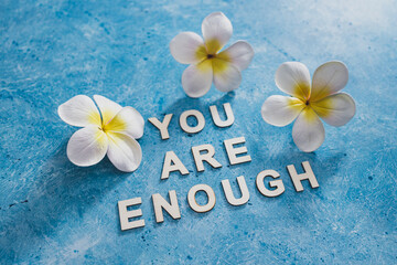 mental health and self-worth concept, You are enouugh text with flowers