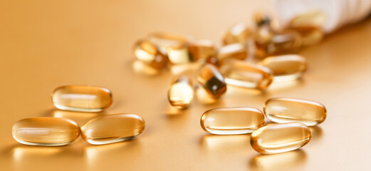 Many capsules Omega 3 on yellow background. Close up, high resolution product. Health care concept.