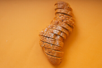 Sliced of loaf bread over orange background.