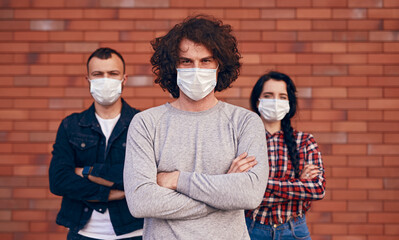 Confident man in mask with friends