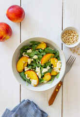 Salad with peach, arugula, cheese, nuts and honey. Healthy eating. Vegetarian food. Recipe.