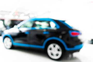Obraz na płótnie Canvas Blurred abstract image of man worker with car in body shop. Blur car auto service. Car bokeh. Blurred background with car in garage. Vehicle maintenance in auto repair service. Blurry service station