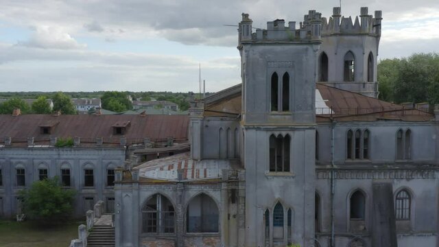 Abandoned 19th century palace  (manor or mansion house) with broken windows in Neo-Gothic (Gothic Revival) style. Aerial side view.  