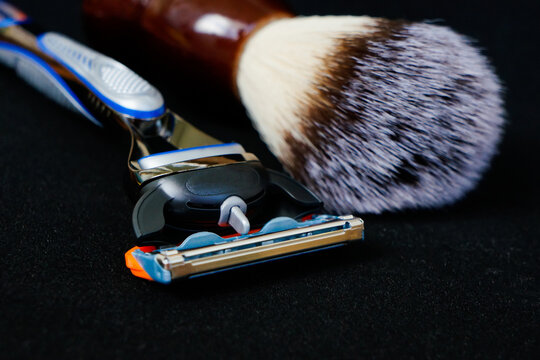 Shaving Razor And Shaving Brush On Black Background Close Up