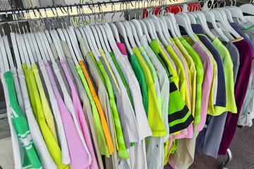 Fashionable clothing on hangers in shop. sport of T Shirts are hanging on Clothes Hanger , Colorful T Shirt. clothes hanger with t shirt.