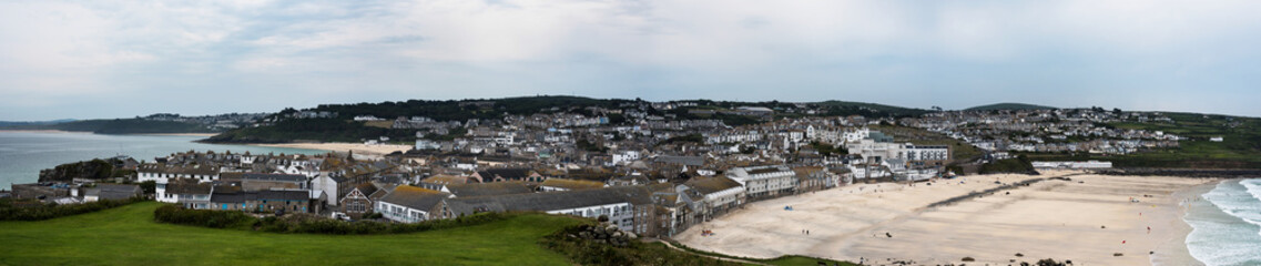 Panorama of Porthmeor Beach in St. Ives at low tide in Cornwall in England.