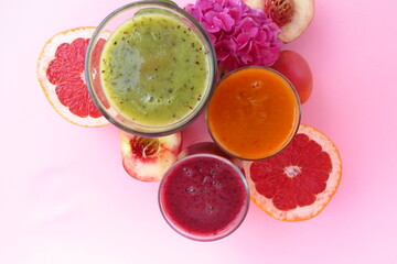 fruit smoothies on a gently pink background, the concept of proper nutrition, proper raw food diet.