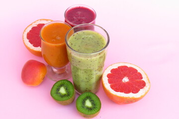 fruit smoothies on a gently pink background, the concept of proper nutrition, proper raw food diet.