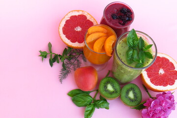 fruit smoothies on a gently pink background, the concept of proper nutrition, proper raw food diet.