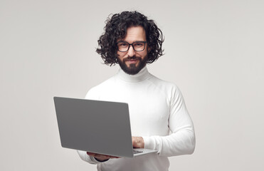 Smart man with laptop looking at camera