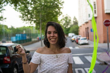 Fototapeta premium Photo of a young and attractive woman playing doing juggle with some colourful strips 