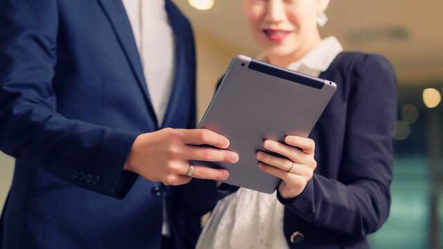 Happy business couple with tablet