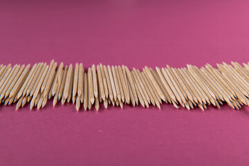 many toothpicks on a lilac violet background: for a food stylist or cook
