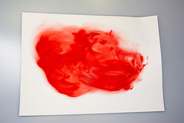 blurred red paint on paper