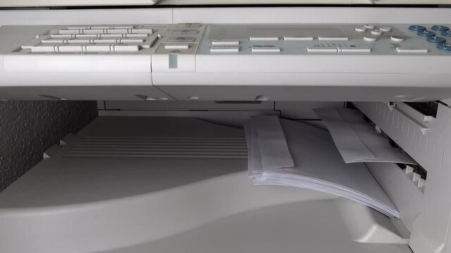 A photocopier in the office prints addresses on envelopes