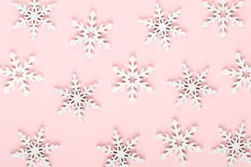 Naklejka na ściany i meble Christmas background. White snow decorations on a pink background.