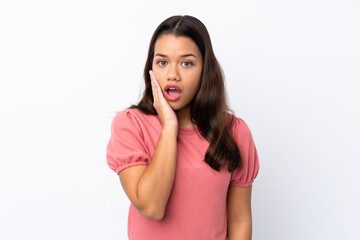 Young Colombian girl over isolated white background surprised and shocked while looking right