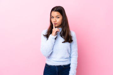 Young Colombian girl over isolated pink background doing silence gesture