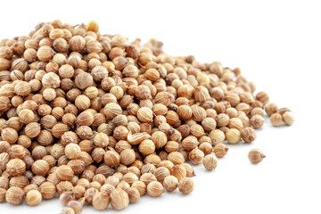 A bunch of coriander seeds close-up on a white background. Selective focus.