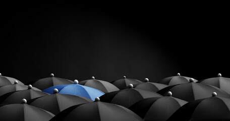 Concept image with lots of black umbrellas and a blue umbrella that stands out