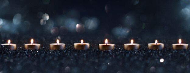 Burning candles a sign of hope
Candlelights in the darkness with blurred golden bokeh. Horizontal...