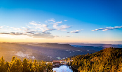 Bright Lake Mummelsee at sunrise, overlooking mountains landscape