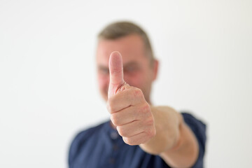 Determined man giving a thumbs up gesture
