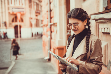 Closeup shot of a beautiful caucasian woman traveling and reading a map to determine her next destination.