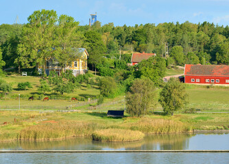 Fototapeta na wymiar Summer landscape. Manor with farm on Baltic Sea. Turku Archipelago, Finland