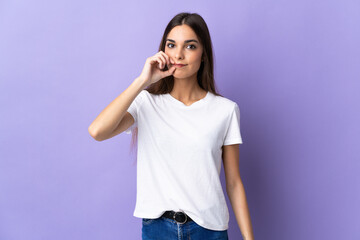 Young caucasian woman isolated on blue background showing a sign of silence gesture