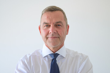 Serious middle-aged businessman in shirt and tie