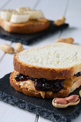 fast food, snack, two sandwiches with peanut butter jam and bananas on a white wooden table