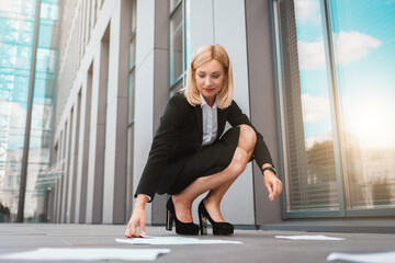 Business lady picks up documents