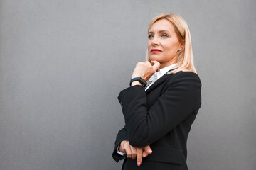 Portrait of a pensive woman in a black business suit