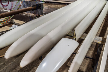 Two sets of new blades for wind generators in the factory floor close-up. The picture was taken in Russia, in the Orenburg region, in the production room of an industrial enterprise