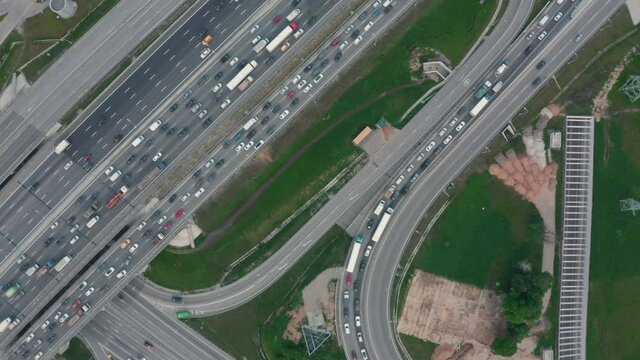 Aerial footage of transport junction, traffic cross road junction cloudy day view from above with circle road. Top down view of traffic jam