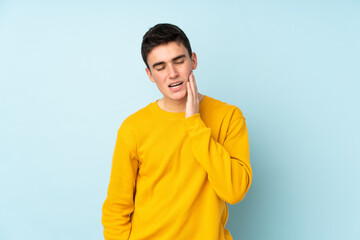 Teenager caucasian handsome man isolated on purple background with toothache
