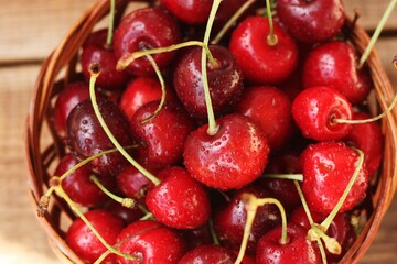 Ripe red cherries on a wooden table