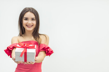 Time for gifts. Completely delighted girl shows her birthday present and enjoys the holiday moment.