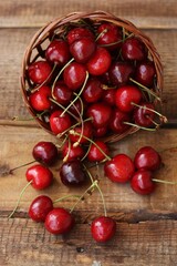 Ripe red cherries on a wooden table