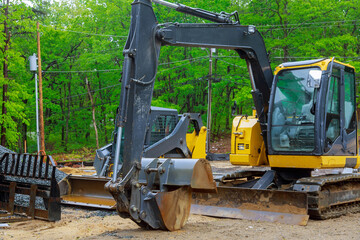 Fototapeta na wymiar Excavator working on a construction site mini excavator equipped