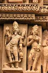 Fototapeta na wymiar Close up of artful carved walls, Ancient reliefs at famous erotic temple in Khajuraho, Madhya Pradesh, India.