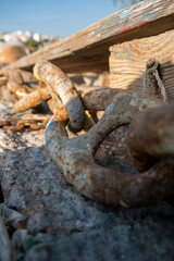 Samos island. Greece. Sea and pythagorion village background. with collorful boats. in the front a big knot and chains
