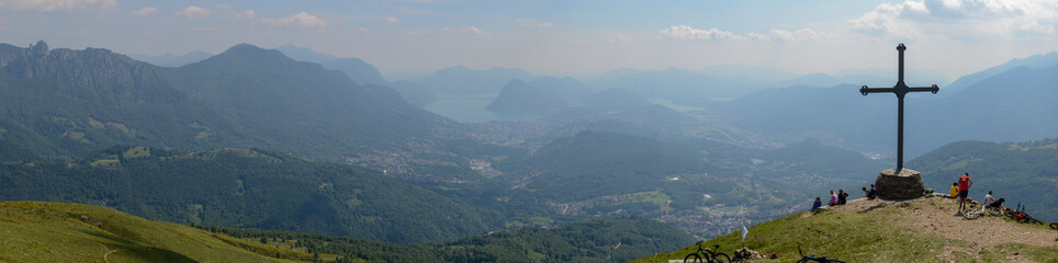 People at cross of Motto on Capriasca velley over Lugano in Switzerland