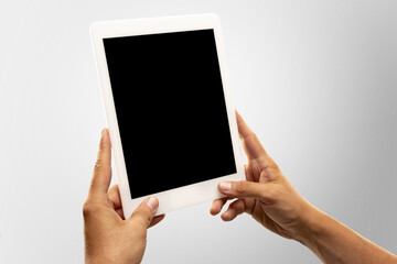 Close up male hands holding tablet with blank screen during online watching of popular sport matches, championships. Copyspace for advertising. Devices, gadgets, technologies concept.
