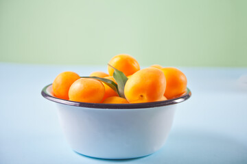 Fresh ripe apricot on the enameled plate
