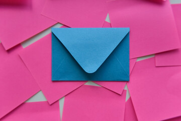 selective focus, blue envelope in the middle of pink stickers